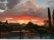 Backyard pool area with dramatic sunset views and privacy landscaping at dusk at 1940 N Stevens Cir, Mesa, AZ 85205