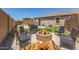 Relaxing backyard featuring a fire pit, seating, and lush landscaping at 20109 W Madison St, Buckeye, AZ 85326
