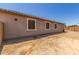 View of the backyard showing the home's exterior and sand at 20109 W Madison St, Buckeye, AZ 85326