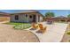 Cozy backyard with patio area, chairs, and well-maintained landscaping at 20109 W Madison St, Buckeye, AZ 85326