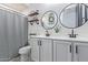 Stylish bathroom with a double sink vanity, modern fixtures, and decorative shelving at 20109 W Madison St, Buckeye, AZ 85326