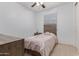 Bright bedroom with a wood frame bed, neutral walls, and a ceiling fan at 20109 W Madison St, Buckeye, AZ 85326