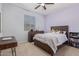 Serene bedroom features a comfortable bed, dresser, a desk, and a ceiling fan, creating a peaceful retreat at 20109 W Madison St, Buckeye, AZ 85326