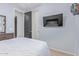 Bright, airy bedroom featuring a mounted TV and a modern minimalist aesthetic at 20109 W Madison St, Buckeye, AZ 85326