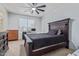 Comfortable bedroom features a ceiling fan, a large window, and a dark wood furniture set at 20109 W Madison St, Buckeye, AZ 85326