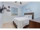 Bright bedroom with blue accent wall, bed, and mounted TV with shelving at 20109 W Madison St, Buckeye, AZ 85326
