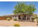 Single-story home featuring a neutral color scheme and desert-style landscaping at 20109 W Madison St, Buckeye, AZ 85326