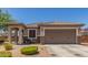 Inviting home exterior showcasing a seating area, a well-manicured front yard, and neutral paint at 20109 W Madison St, Buckeye, AZ 85326