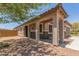 Covered front porch with welcoming columns, offering shade and curb appeal to the home at 20109 W Madison St, Buckeye, AZ 85326