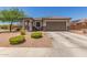 Charming single-story home with a well-maintained front yard and a two-car garage at 20109 W Madison St, Buckeye, AZ 85326