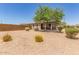 Low-maintenance landscaping surrounds this single-story home, with desert landscaping at 20109 W Madison St, Buckeye, AZ 85326