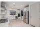 Gourmet kitchen features stainless steel appliances, sleek white cabinets, granite counters, and a large center island at 20109 W Madison St, Buckeye, AZ 85326