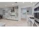Open kitchen boasts white cabinetry, stainless steel appliances, granite counters, and access to a breakfast nook at 20109 W Madison St, Buckeye, AZ 85326
