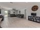 Spacious living room with sleek tile floors, modern ceiling fan, and neutral decor at 20109 W Madison St, Buckeye, AZ 85326