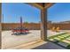 Outdoor patio featuring a dining set, Adirondack chairs, and artificial turf accents at 20109 W Madison St, Buckeye, AZ 85326
