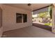 The home's covered patio features a ceiling fan, block wall fencing, and desert landscaping at 20632 N 103Rd Ave, Peoria, AZ 85382