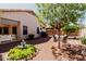 Picturesque backyard features fountain, patio furniture, landscaped garden beds and mature trees at 20632 N 103Rd Ave, Peoria, AZ 85382
