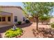 Landscaped backyard with mature trees, small shrubs, and a charming fountain feature at 20632 N 103Rd Ave, Peoria, AZ 85382