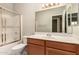 Bathroom featuring a vanity, shower with glass door, and tile flooring at 20632 N 103Rd Ave, Peoria, AZ 85382