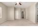 Bright bedroom featuring neutral walls, carpet flooring, and a ceiling fan with an attached light at 20632 N 103Rd Ave, Peoria, AZ 85382