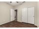 Bedroom featuring wood-look flooring and a closet with sliding doors at 20632 N 103Rd Ave, Peoria, AZ 85382