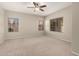 Spacious bedroom featuring neutral walls, carpet flooring, and a ceiling fan with an attached light at 20632 N 103Rd Ave, Peoria, AZ 85382