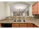 Kitchen features granite countertops, stainless steel appliances, and oak cabinetry with a view to the living room at 20632 N 103Rd Ave, Peoria, AZ 85382
