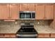 Kitchen features granite countertops, stainless steel appliances, and oak cabinetry at 20632 N 103Rd Ave, Peoria, AZ 85382
