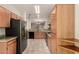 Spacious kitchen with granite countertops, stainless steel appliances, and oak cabinetry at 20632 N 103Rd Ave, Peoria, AZ 85382