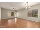 Bright living room features wood floors, a ceiling fan, recessed lighting, and backyard access at 20632 N 103Rd Ave, Peoria, AZ 85382