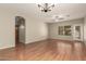 Bright living room features wood floors, a ceiling fan, recessed lighting, and backyard access at 20632 N 103Rd Ave, Peoria, AZ 85382