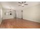Bright living room features wood floors, a ceiling fan, recessed lighting, and backyard access at 20632 N 103Rd Ave, Peoria, AZ 85382
