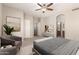 Elegant main bedroom with a sitting area and a view into the main bathroom at 20632 N 103Rd Ave, Peoria, AZ 85382