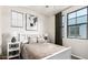 Cozy bedroom featuring a white bed frame, neutral tones, and a large window at 2090 S Dorsey Ln # 1019, Tempe, AZ 85282