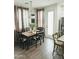 Cozy dining area featuring a wooden table, seating for six, stylish curtains, and modern light fixture at 2090 S Dorsey Ln # 1019, Tempe, AZ 85282