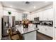 Modern kitchen with stainless steel appliances, gray countertops and white cabinetry at 2090 S Dorsey Ln # 1019, Tempe, AZ 85282
