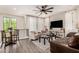 Open-concept living room boasts a ceiling fan, modern furniture, and lots of natural light from large windows at 2090 S Dorsey Ln # 1019, Tempe, AZ 85282