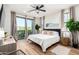 Relaxing main bedroom offers a sliding glass door to a balcony and neutral decor with wood-look flooring at 2090 S Dorsey Ln # 1019, Tempe, AZ 85282
