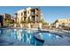 Community pool and jacuzzi with lounge chairs and blue skies in the background at 2090 S Dorsey Ln # 1019, Tempe, AZ 85282
