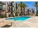 Community pool surrounded by lounge chairs and palm trees at 2090 S Dorsey Ln # 1019, Tempe, AZ 85282