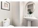 Cozy powder room features a pedestal sink, toilet, and a framed picture on the wall for added decor at 2090 S Dorsey Ln # 1019, Tempe, AZ 85282