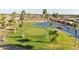 Aerial view of the golf course, featuring lush greenery, palm trees, and the surrounding community at 2249 N Shannon Way, Mesa, AZ 85215