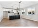 Bright, open-concept kitchen featuring a central island, modern lighting, and a full view of the dining area at 2249 N Shannon Way, Mesa, AZ 85215