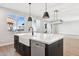 Close-up of kitchen island with white countertop, modern faucet, farmhouse sink, and stainless steel appliances at 2249 N Shannon Way, Mesa, AZ 85215