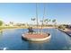 Sculpture in the middle of a pond, showcasing waterfront views with palm trees in a sunny community at 2249 N Shannon Way, Mesa, AZ 85215