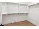 Walk-in closet featuring lots of storage shelves and hardwood flooring at 2249 N Shannon Way, Mesa, AZ 85215