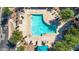 Beautiful community pool featuring sun-bathing chairs, landscaping, and geometric design at 240 W Juniper Ave # 1020, Gilbert, AZ 85233