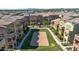 Aerial view showcasing community volleyball court, green space, and a playground at 240 W Juniper Ave # 1020, Gilbert, AZ 85233