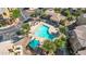 Aerial shot of a community pool featuring sunbathing chairs, nearby parking, and landscaping at 240 W Juniper Ave # 1020, Gilbert, AZ 85233
