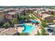 Community aerial view showcasing the swimming pool and playground among lush landscaping at 240 W Juniper Ave # 1020, Gilbert, AZ 85233